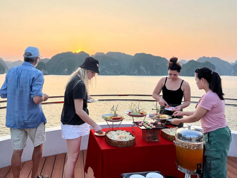 Golden hour sunset party on the Dcharme Lan Ha Bay day cruise from Cat Ba