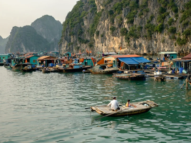 Tourists kayaking through the traditional floating houses of Cai Beo floating village in Cat Ba Island