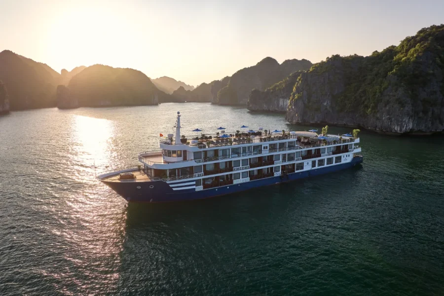 Panoramic view of the 5-star Erina Cruise sailing in Lan Ha Bay at sunset