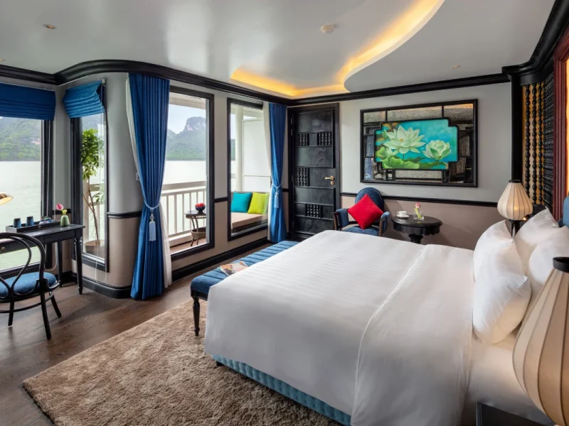 Luxury Deluxe cabin with private balcony on Aurora boutique cruise Lan Ha Bay featuring elegant wooden interior